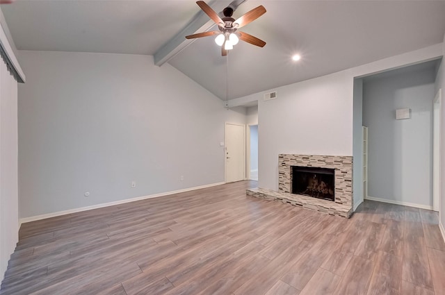 unfurnished living room with vaulted ceiling with beams and hardwood / wood-style flooring