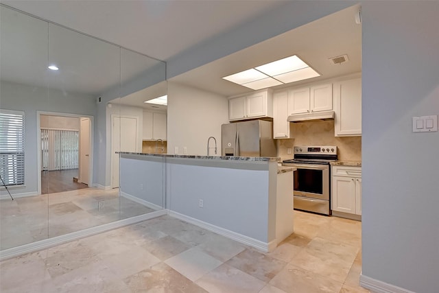 kitchen with white cabinets, light stone counters, appliances with stainless steel finishes, and tasteful backsplash