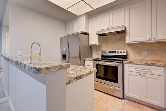 kitchen featuring light stone countertops, decorative backsplash, white cabinetry, and stainless steel appliances