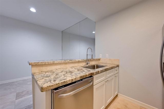 kitchen featuring light stone countertops, white cabinetry, sink, stainless steel dishwasher, and kitchen peninsula