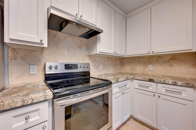 kitchen with electric range, backsplash, white cabinetry, and light stone counters