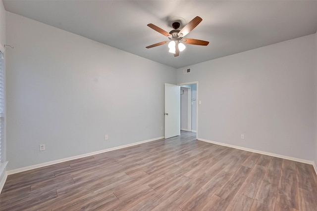 empty room with ceiling fan and wood-type flooring