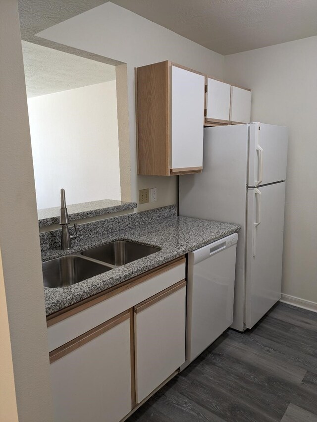 2300 Stone Hollow Dr, Brenham, TX 77833 - kitchen featuring dishwasher, dark wood-style floors, white cabinets, and light stone countertops