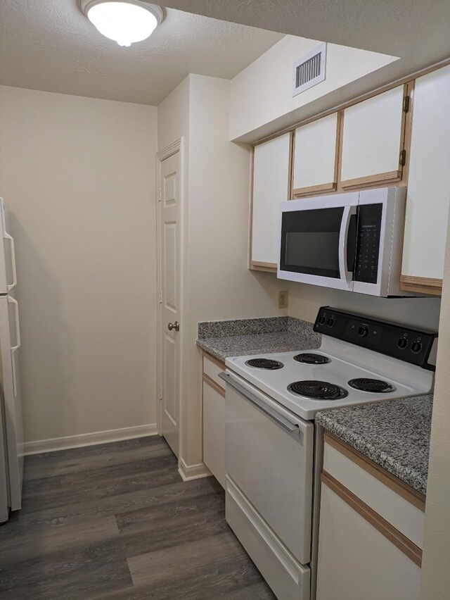 2300 Stone Hollow Dr, Brenham, TX 77833 - kitchen featuring white appliances, dark wood finished floors, and white cabinetry