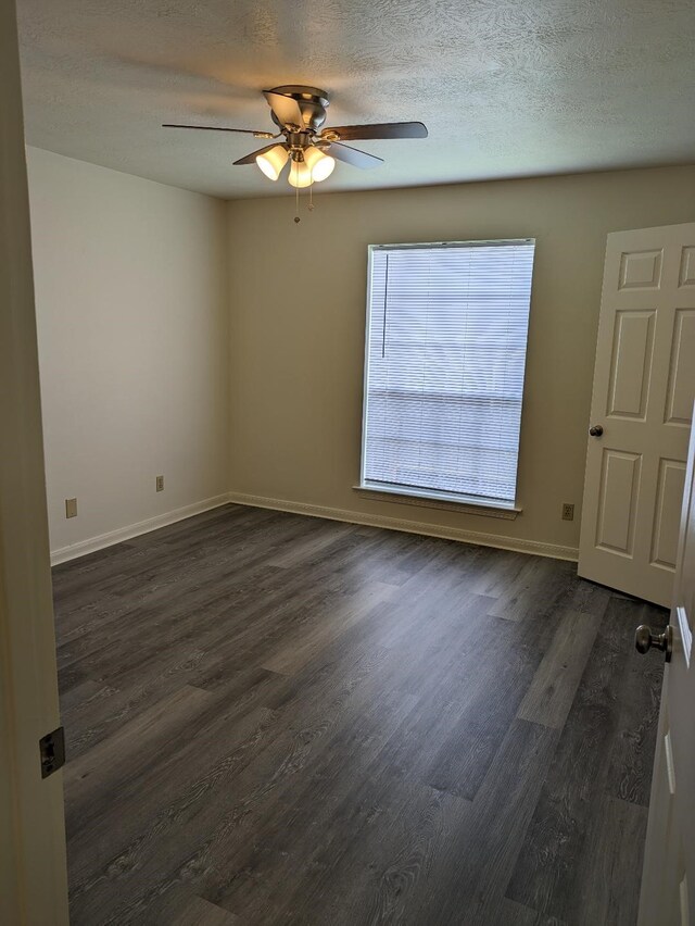 2300 Stone Hollow Dr, Brenham, TX 77833 - unfurnished room with ceiling fan, dark wood-type flooring, and a textured ceiling