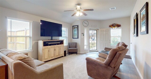 living room featuring ceiling fan and a wealth of natural light