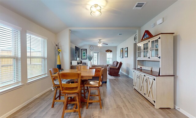 dining area with lofted ceiling, light hardwood / wood-style flooring, and ceiling fan