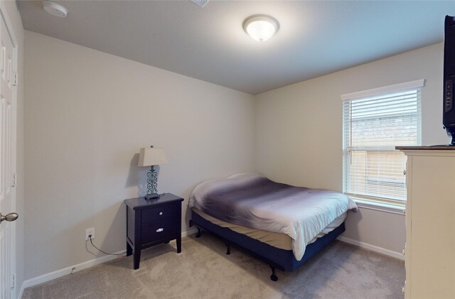 bedroom with light colored carpet