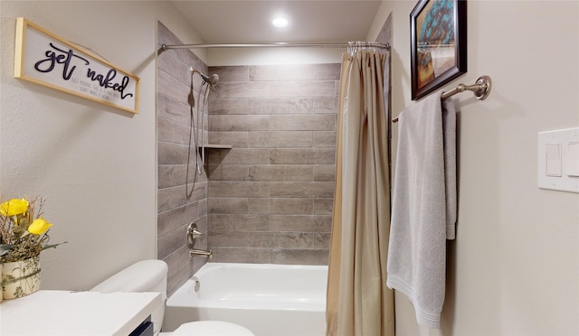 full bathroom with toilet, vanity, and shower / tub combo