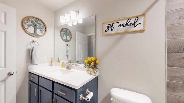 bathroom featuring toilet and vanity