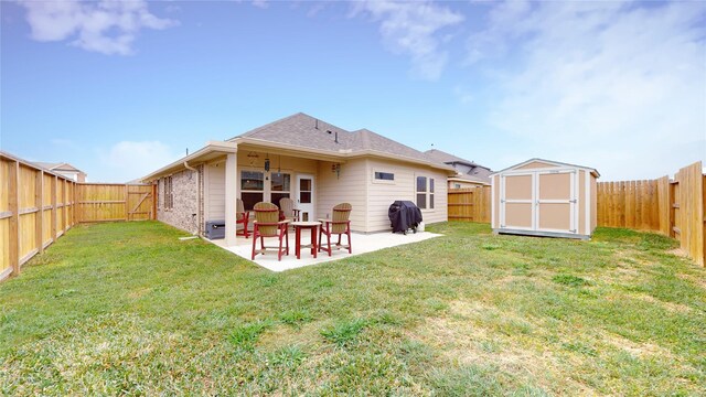 rear view of property with a patio, a shed, and a yard