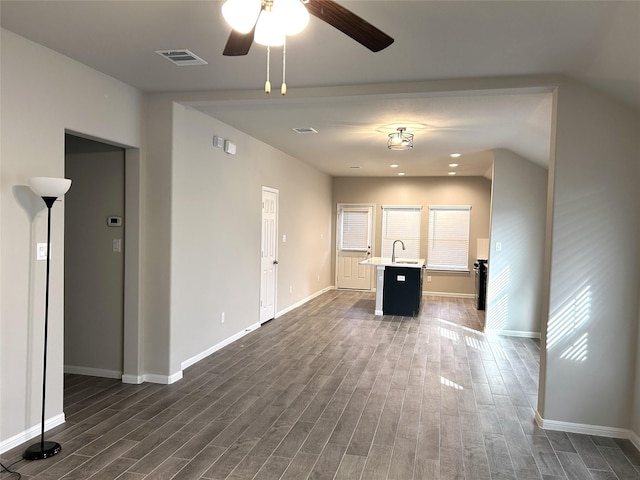 unfurnished living room with sink, dark hardwood / wood-style floors, and ceiling fan