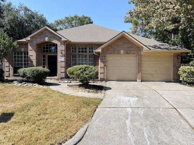 ranch-style home featuring a garage and a front lawn