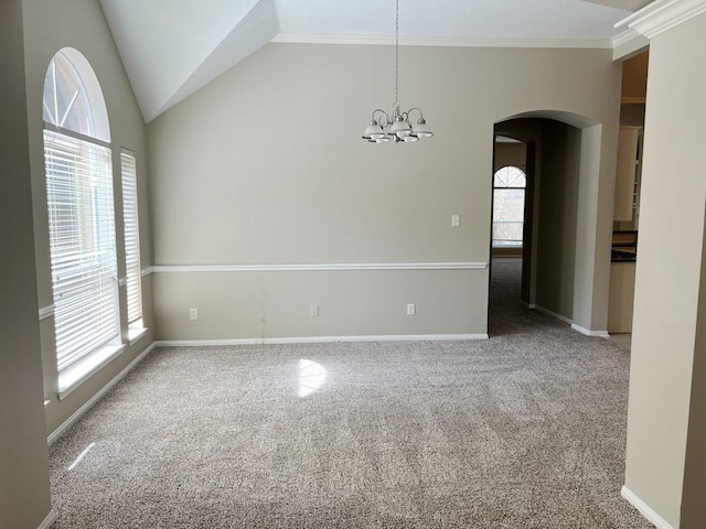 unfurnished room with carpet, a chandelier, lofted ceiling, and ornamental molding