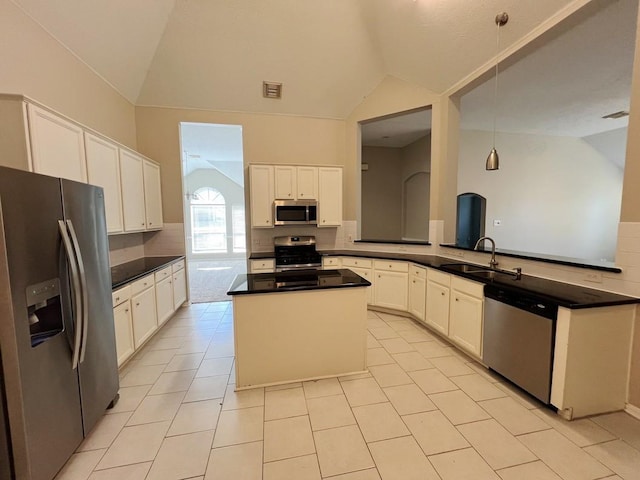 kitchen featuring white cabinetry, sink, stainless steel appliances, pendant lighting, and lofted ceiling