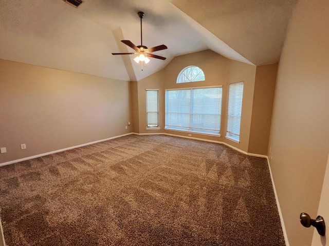 empty room featuring carpet, ceiling fan, and lofted ceiling