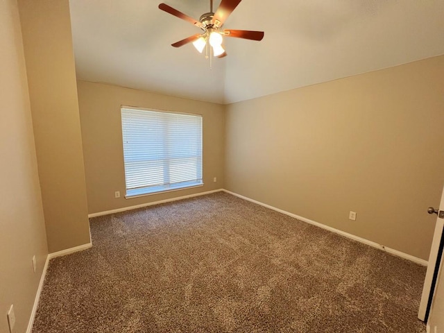 spare room with ceiling fan and dark carpet