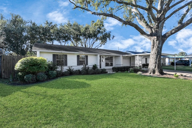 ranch-style house featuring a carport and a front lawn