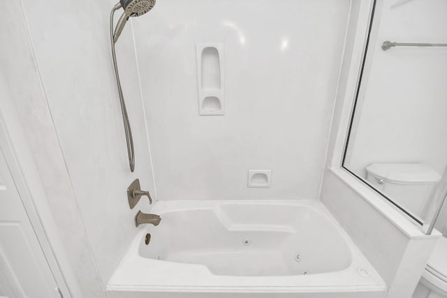 bathroom featuring shower / bathing tub combination and toilet