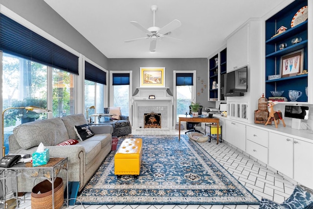 living room featuring built in shelves and ceiling fan