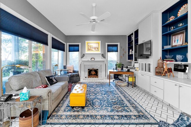 living room featuring built in features and ceiling fan