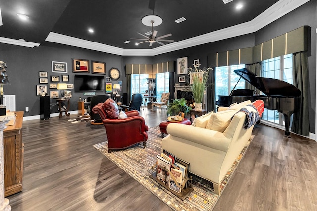 living room featuring dark wood-type flooring, ornamental molding, and ceiling fan