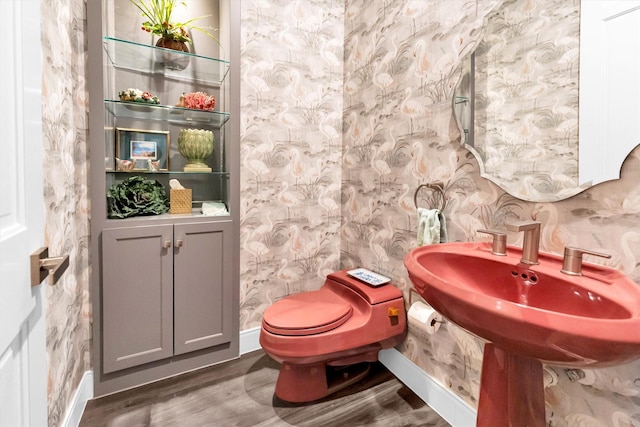 bathroom featuring wood-type flooring and toilet