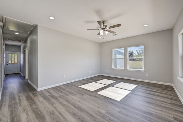 unfurnished room featuring a wealth of natural light, ceiling fan, and dark wood-type flooring