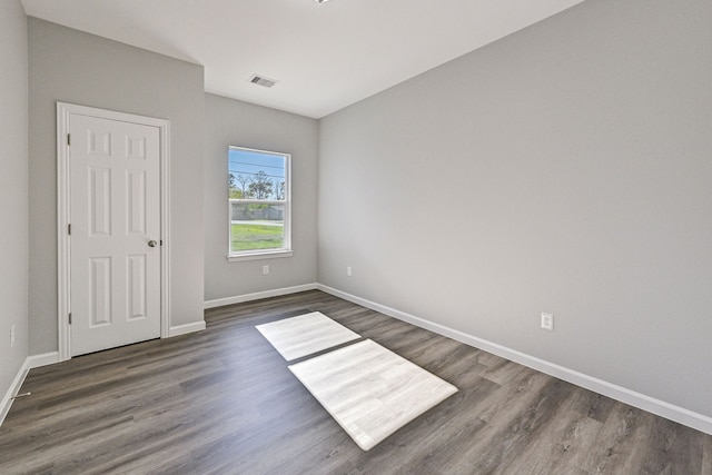 spare room with dark hardwood / wood-style flooring