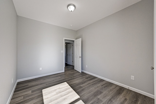 unfurnished room featuring dark hardwood / wood-style flooring