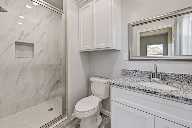 bathroom with hardwood / wood-style floors, vanity, toilet, and a shower with shower door