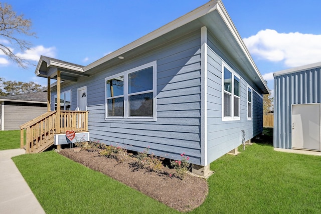 view of side of property with a lawn