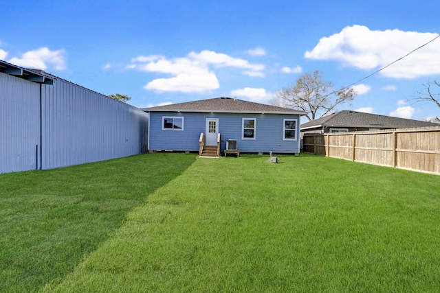 rear view of house with a yard