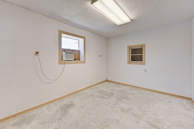 empty room with cooling unit and a textured ceiling