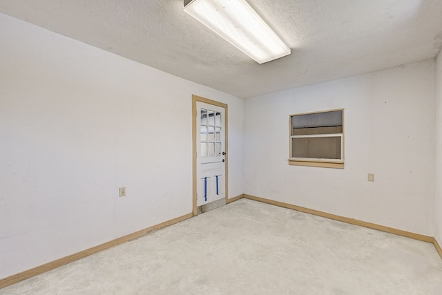 unfurnished room featuring a textured ceiling