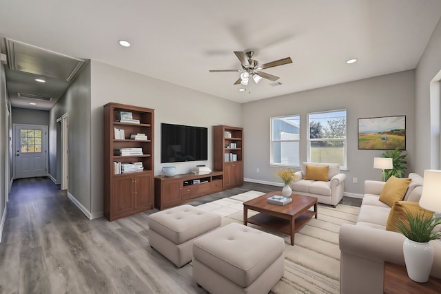 living room with hardwood / wood-style floors and ceiling fan