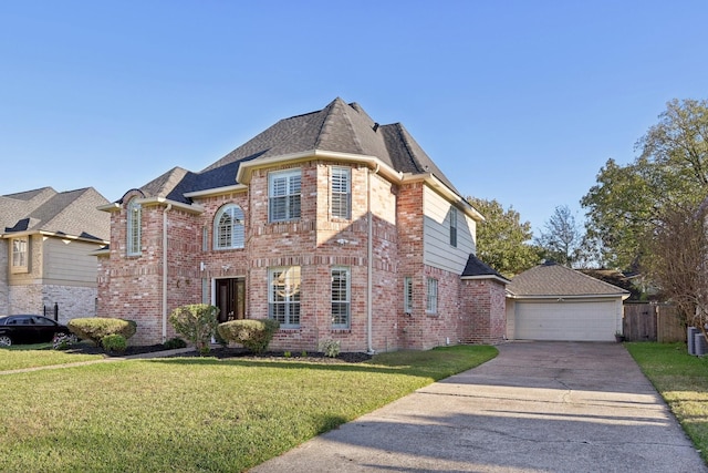 view of front of house with a front yard, central AC, an outbuilding, and a garage