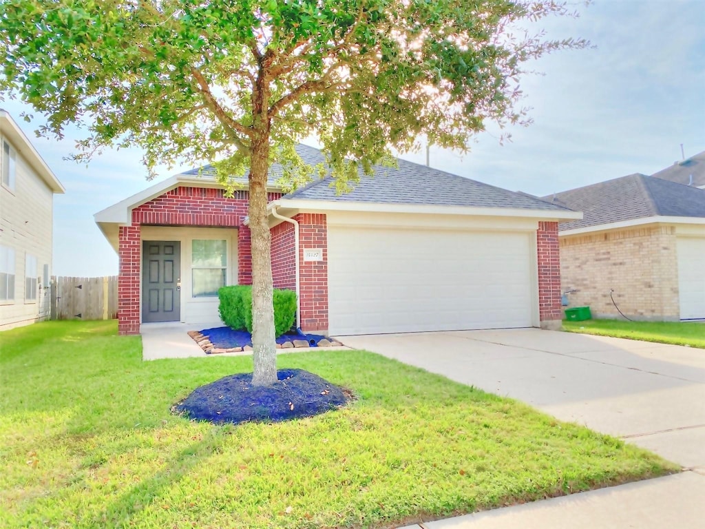 single story home featuring a front yard and a garage