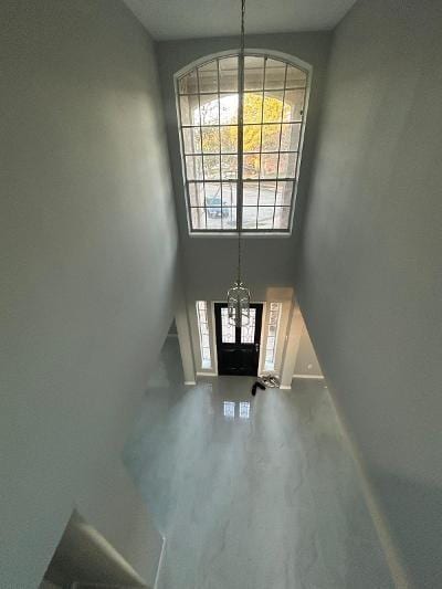 foyer entrance with a high ceiling and an inviting chandelier