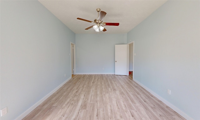 empty room with ceiling fan and light hardwood / wood-style flooring