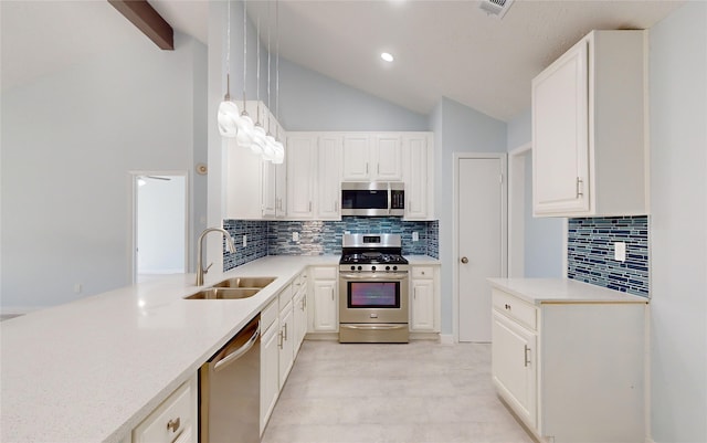 kitchen with white cabinets, stainless steel appliances, hanging light fixtures, and sink