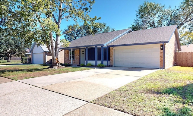 ranch-style house featuring a front yard and a garage