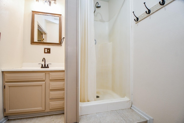 bathroom with tile patterned floors, a shower with curtain, and vanity