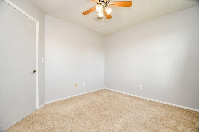 unfurnished room featuring ceiling fan, carpet floors, and a textured ceiling