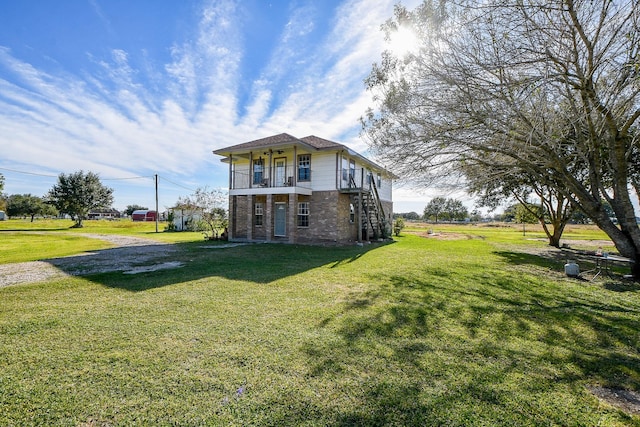 view of front of property with a balcony and a front lawn