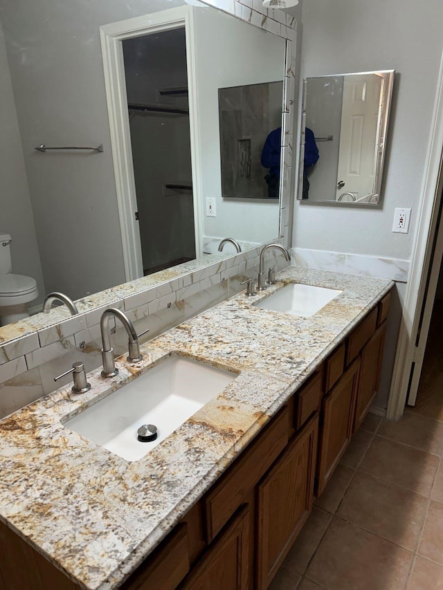 bathroom with tile patterned floors, toilet, and vanity