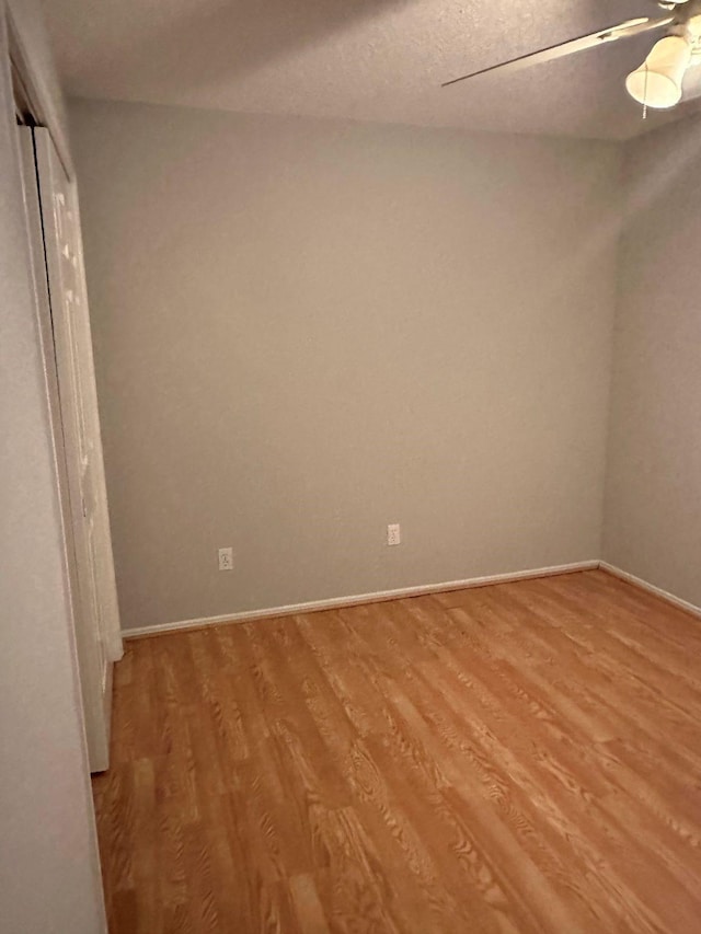 empty room featuring ceiling fan, a textured ceiling, and light hardwood / wood-style flooring