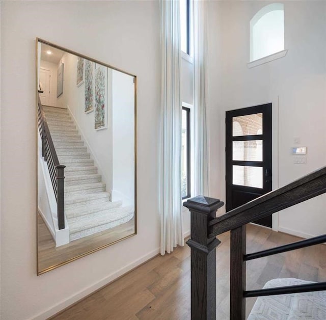 staircase with hardwood / wood-style flooring