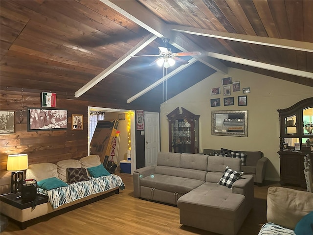 living room featuring hardwood / wood-style floors, vaulted ceiling with beams, ceiling fan, and wood ceiling