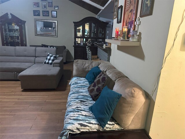 living room featuring hardwood / wood-style floors and vaulted ceiling